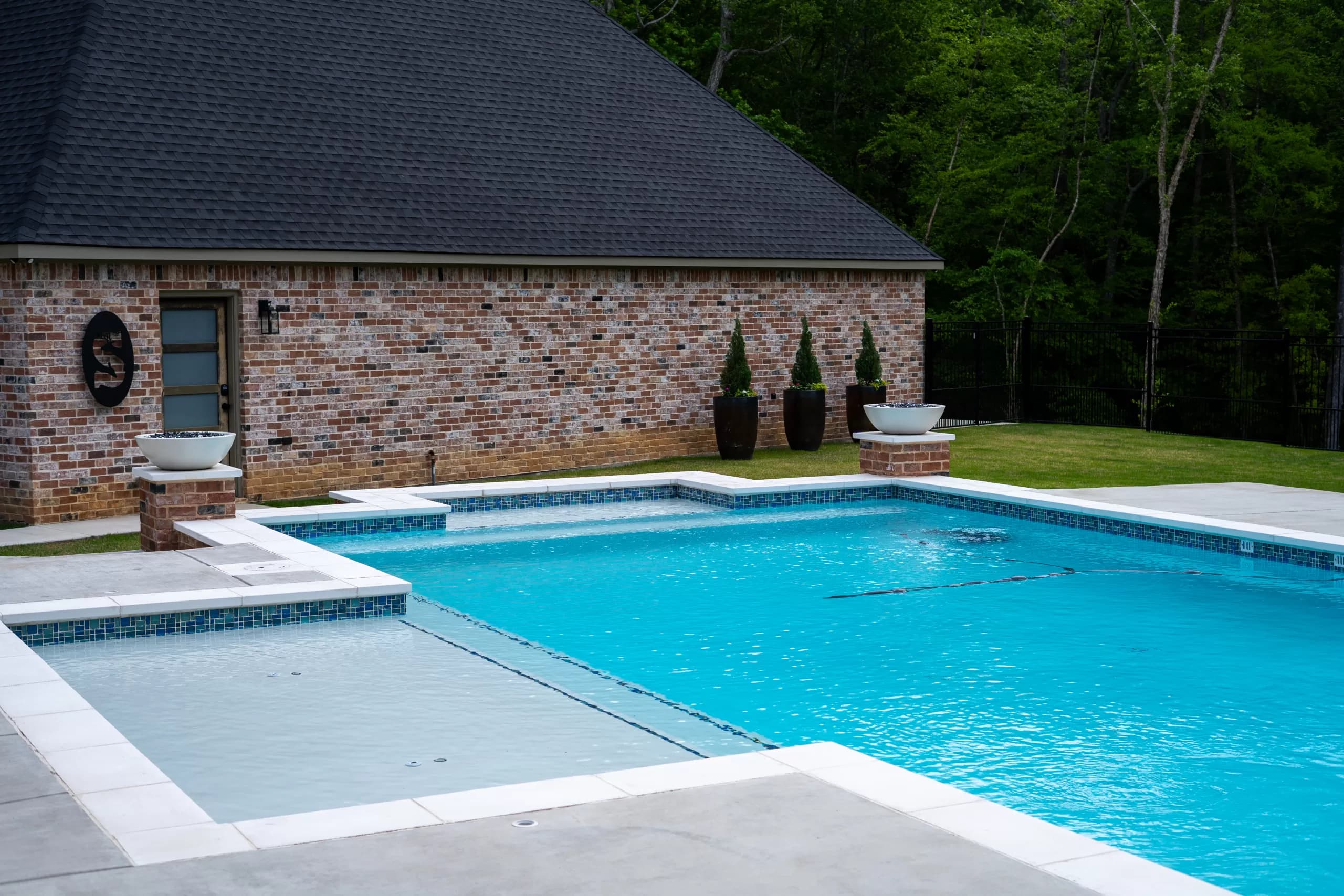 Finished pool edge with natural stone coping and a tile waterline, Natural Stone Coping: Finished