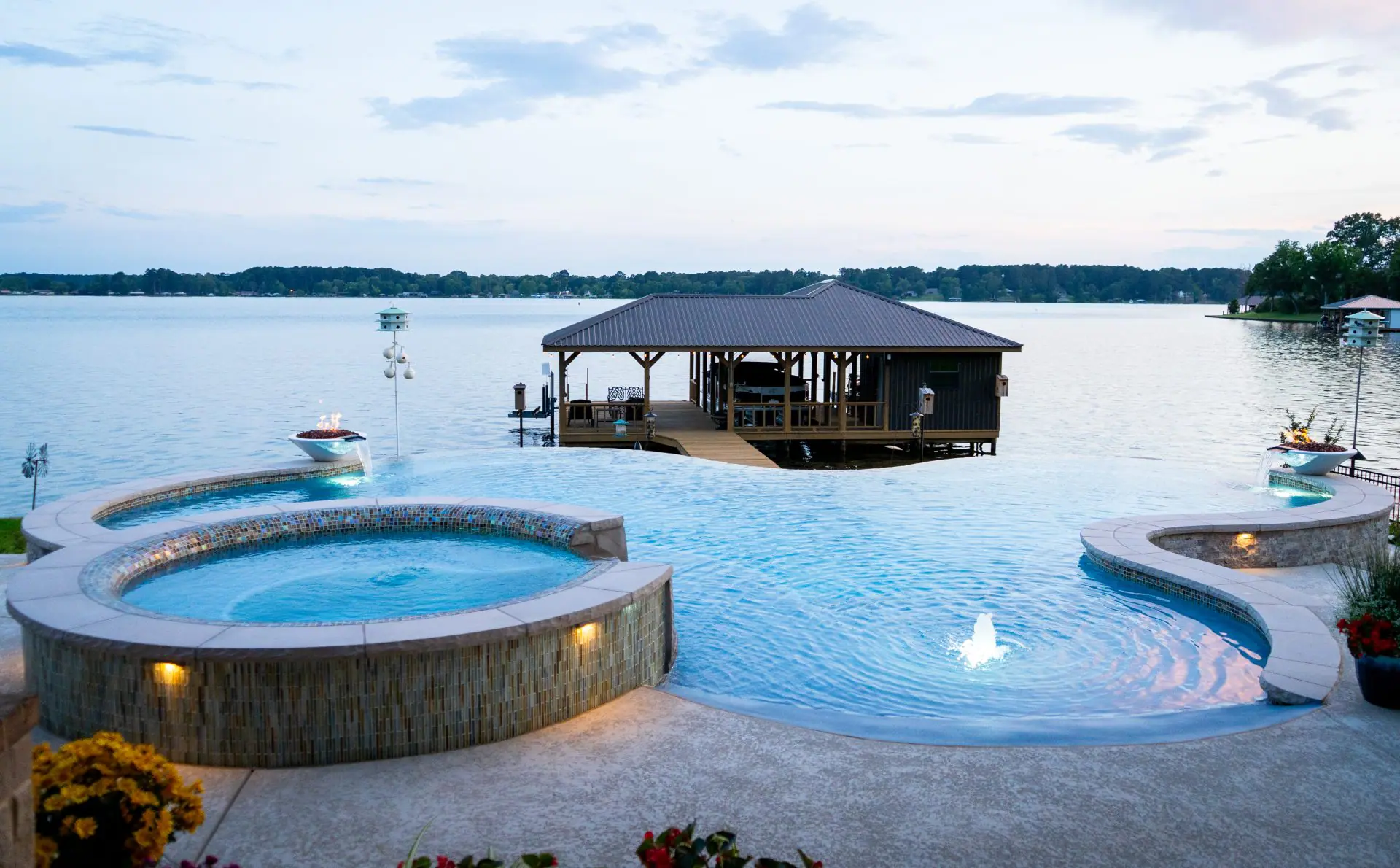 Finished round spa beside a negative edge pool with a lake view, Custom Spas & Hot Tubs: Finished