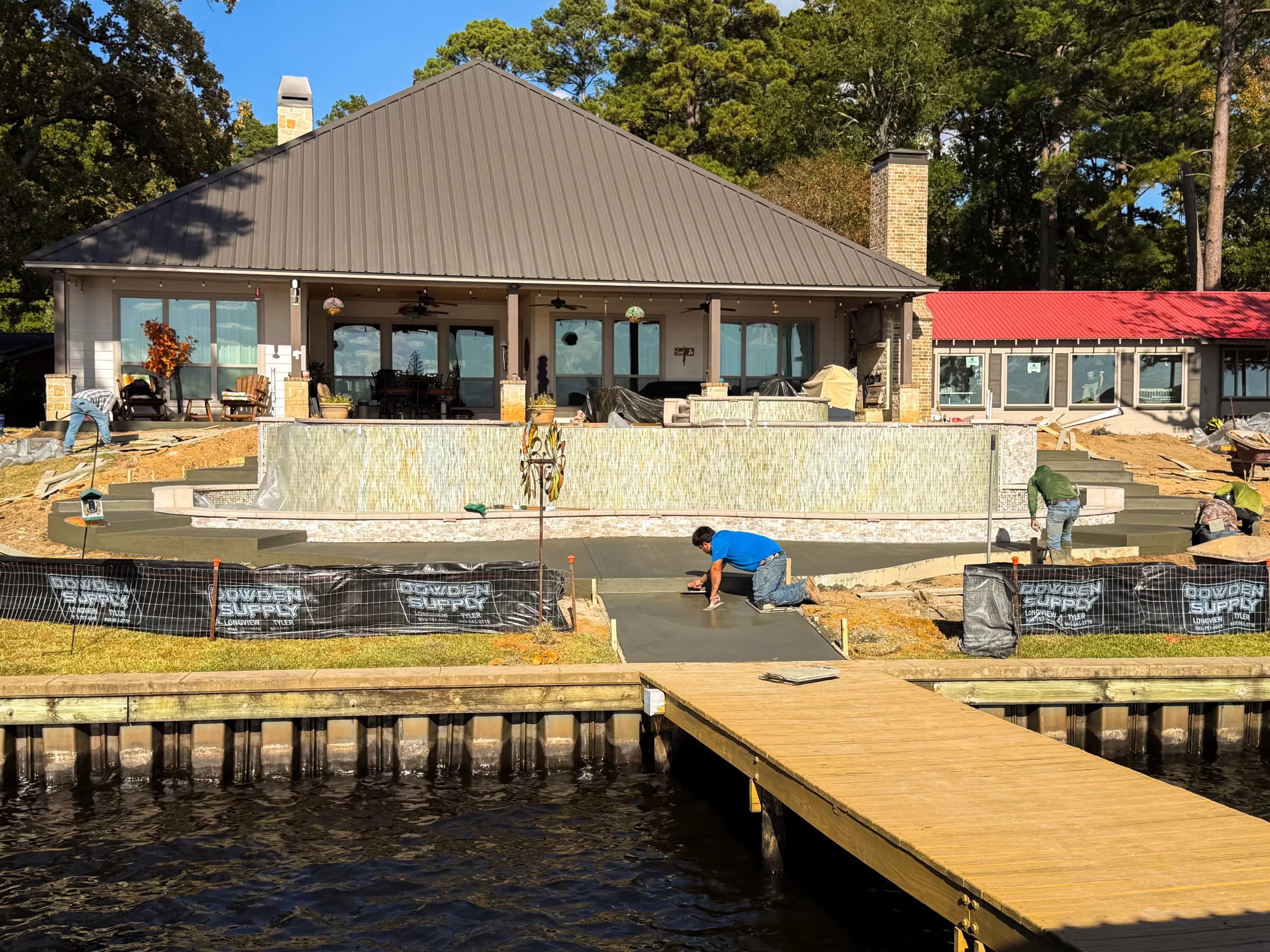 Crew at work on a custom pool and deck during construction
