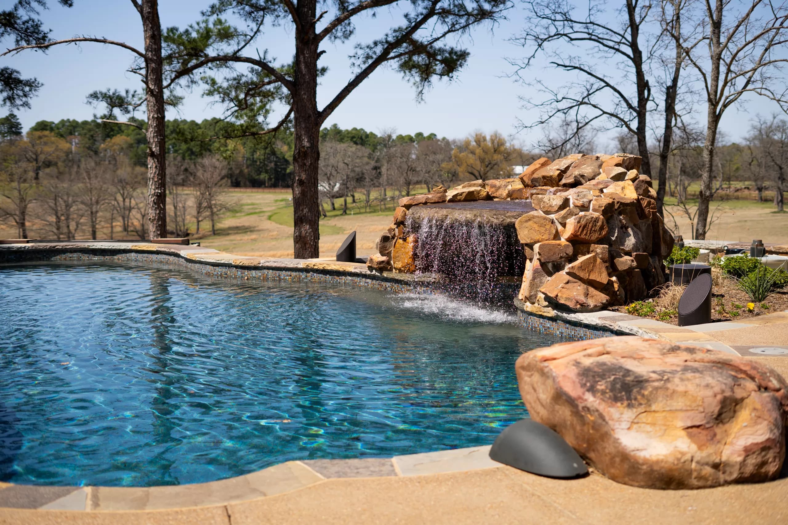 Pool with a natural rock waterfall spilling into the water